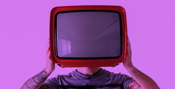 Man holding up TV as the header image for MESH's blog on Digital Media Buying 101
